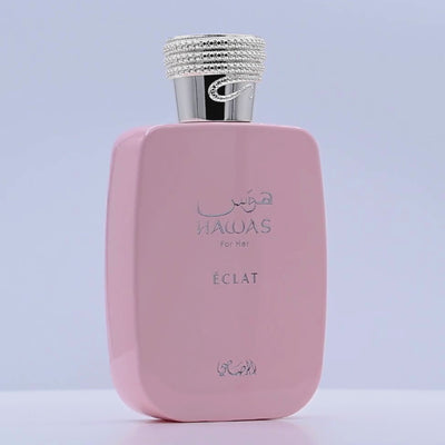 Pink HAWAS Eclat perfume bottle rotating on a white podium
