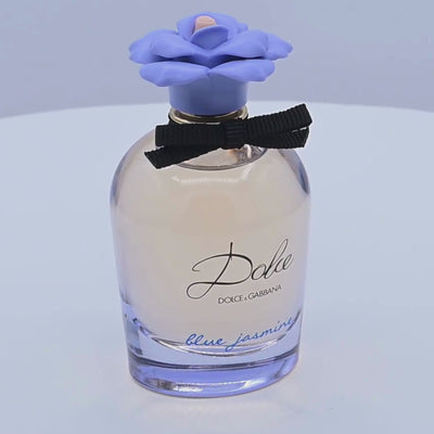 Dolce & Gabbana perfume bottle rotating on a white podium
