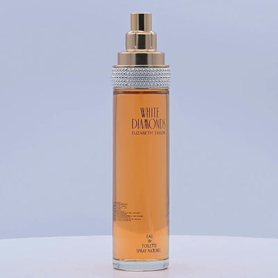 Perfume bottle with gold and silver cap rotating on a white podium