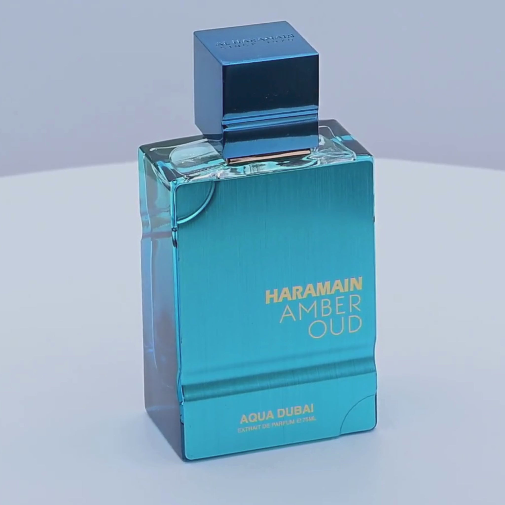 Haramain Amber Oud perfume bottle rotating on a white podium