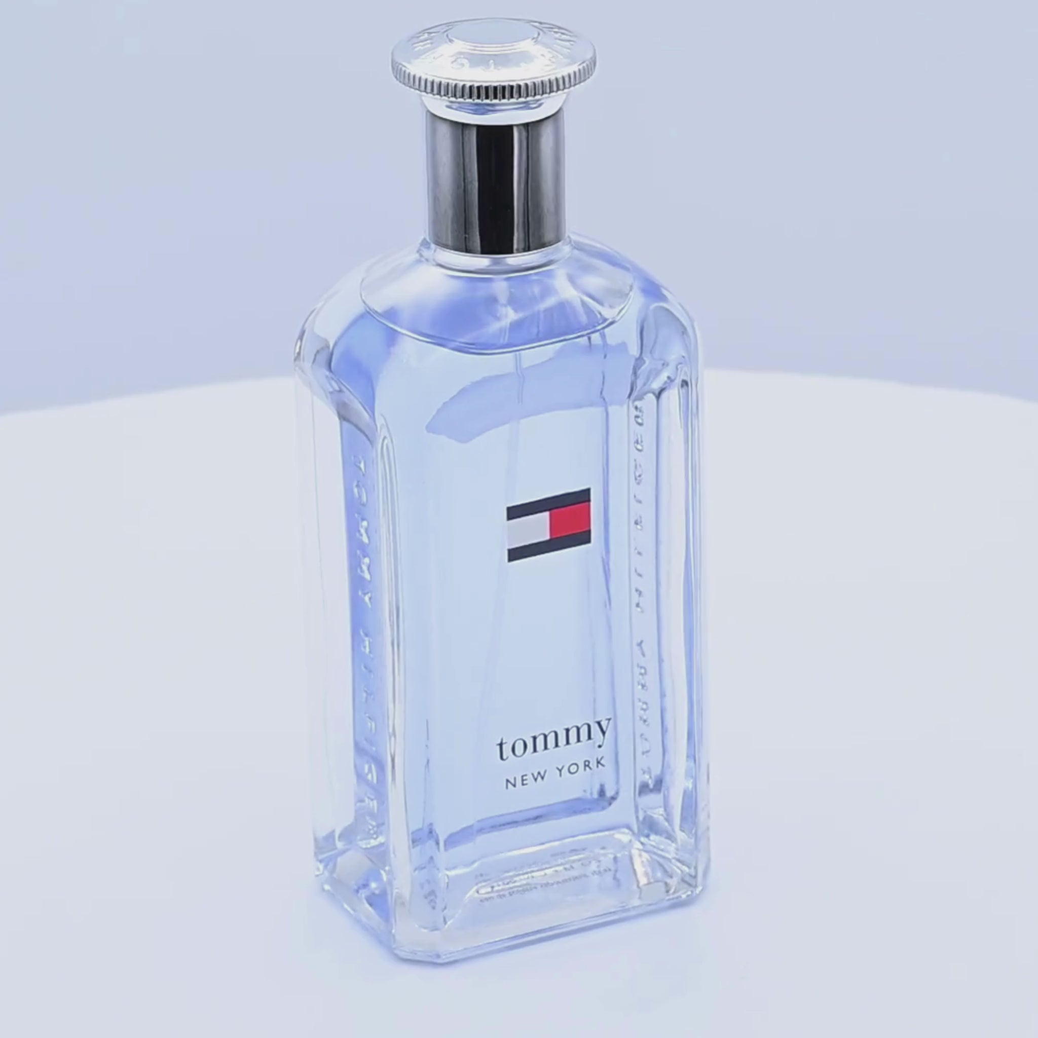 Tommy Hilfiger Tommy New York perfume bottle rotating on  white podium