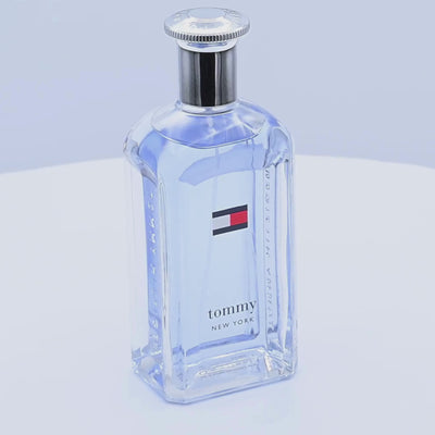 Tommy Hilfiger Tommy New York perfume bottle rotating on  white podium
