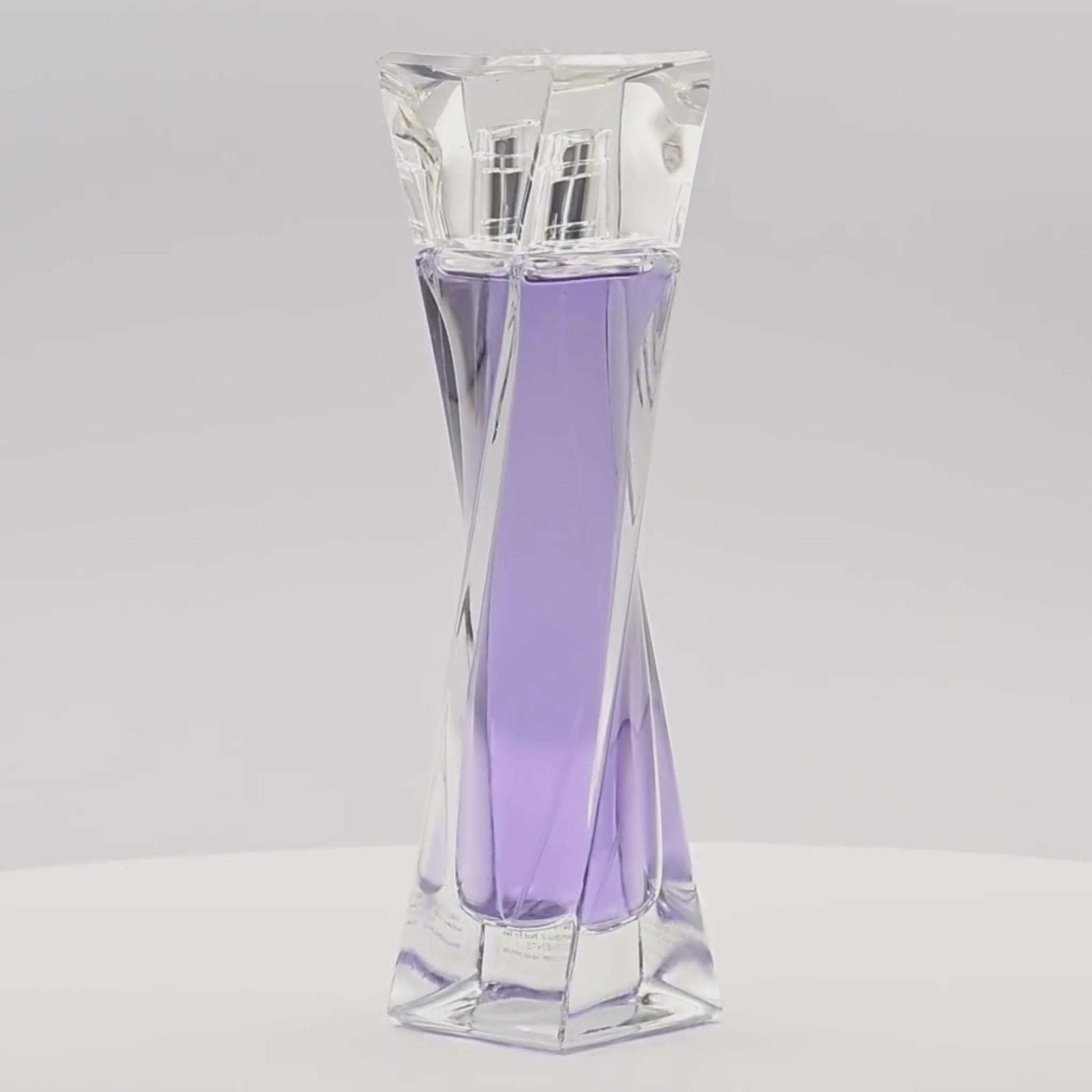 Lancème Hypnôse perfume bottle rotating on a white podium
