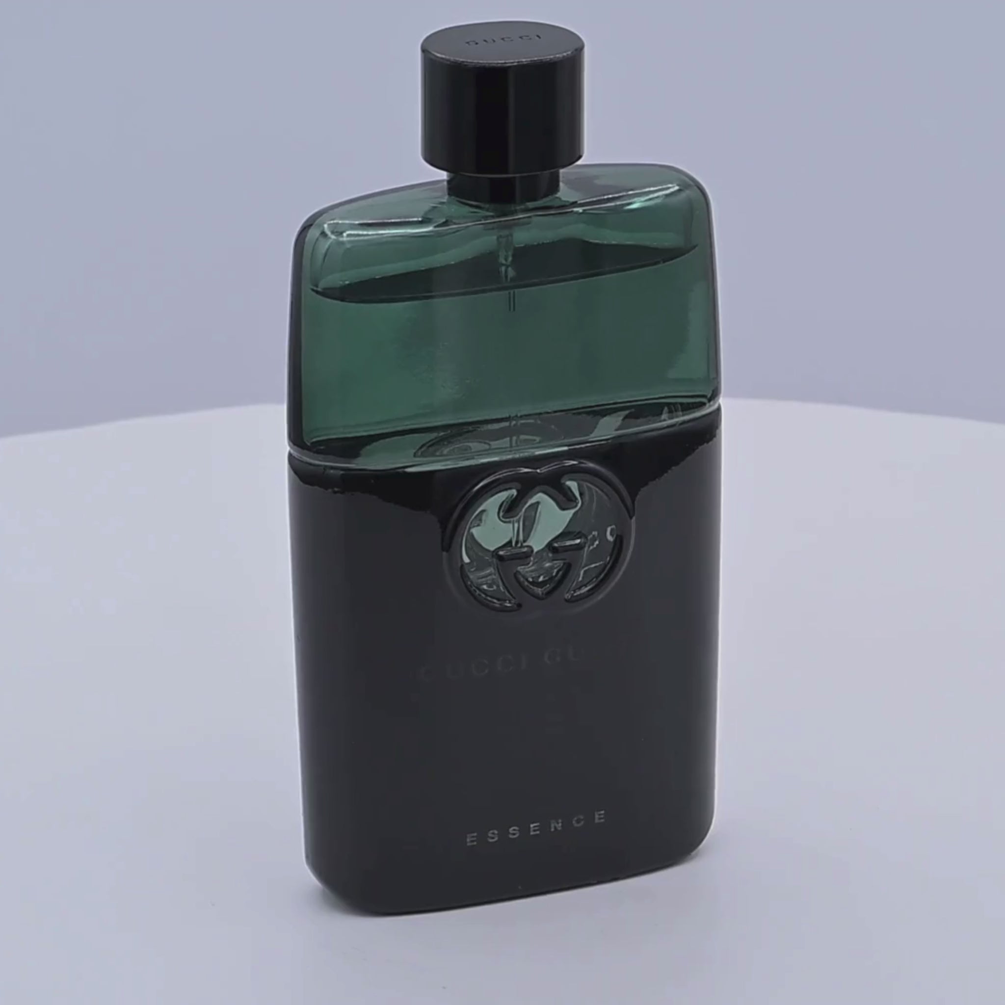 Gucci Guilty perfume bottle rotating on a white podium