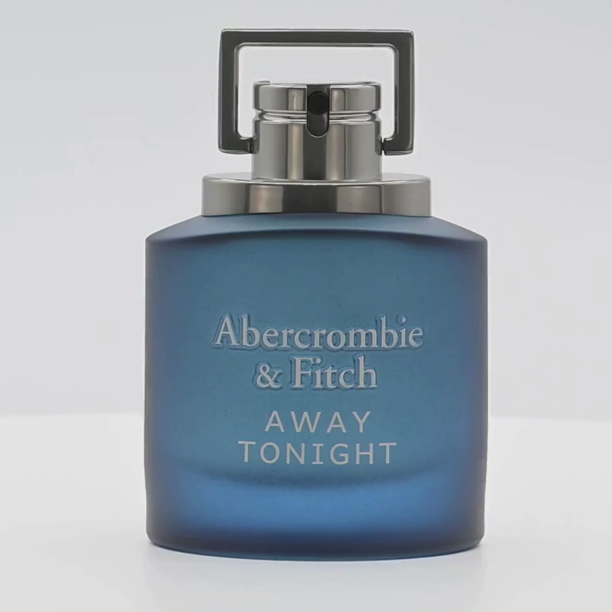 Abercrombie & Fitch Away Tonight  perfume bottle rotating on a white podium
