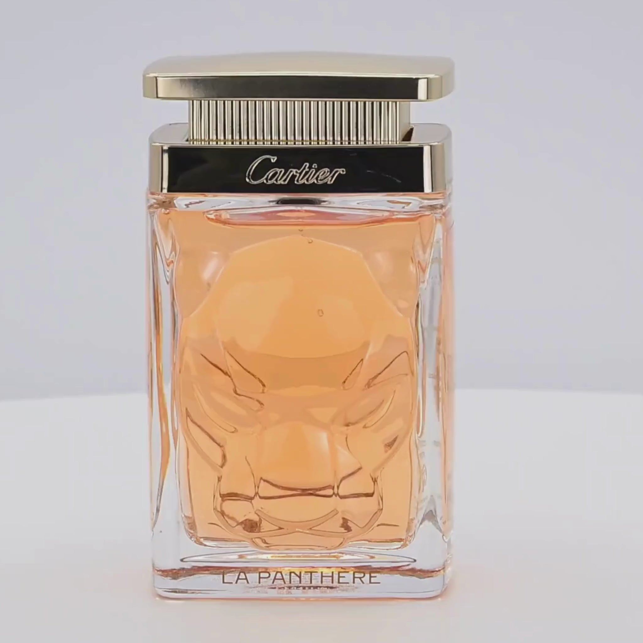 Cartier La Panthere perfume bottle rotating on a white podium