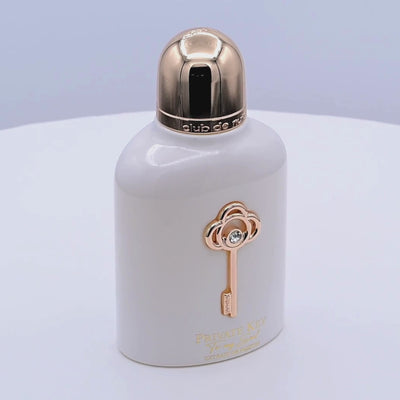 Perfume bottle with gold cap and key design rotating on a white podium