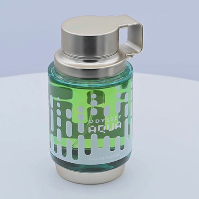 Odyssey Aqua perfume bottle rotating on a white podium
