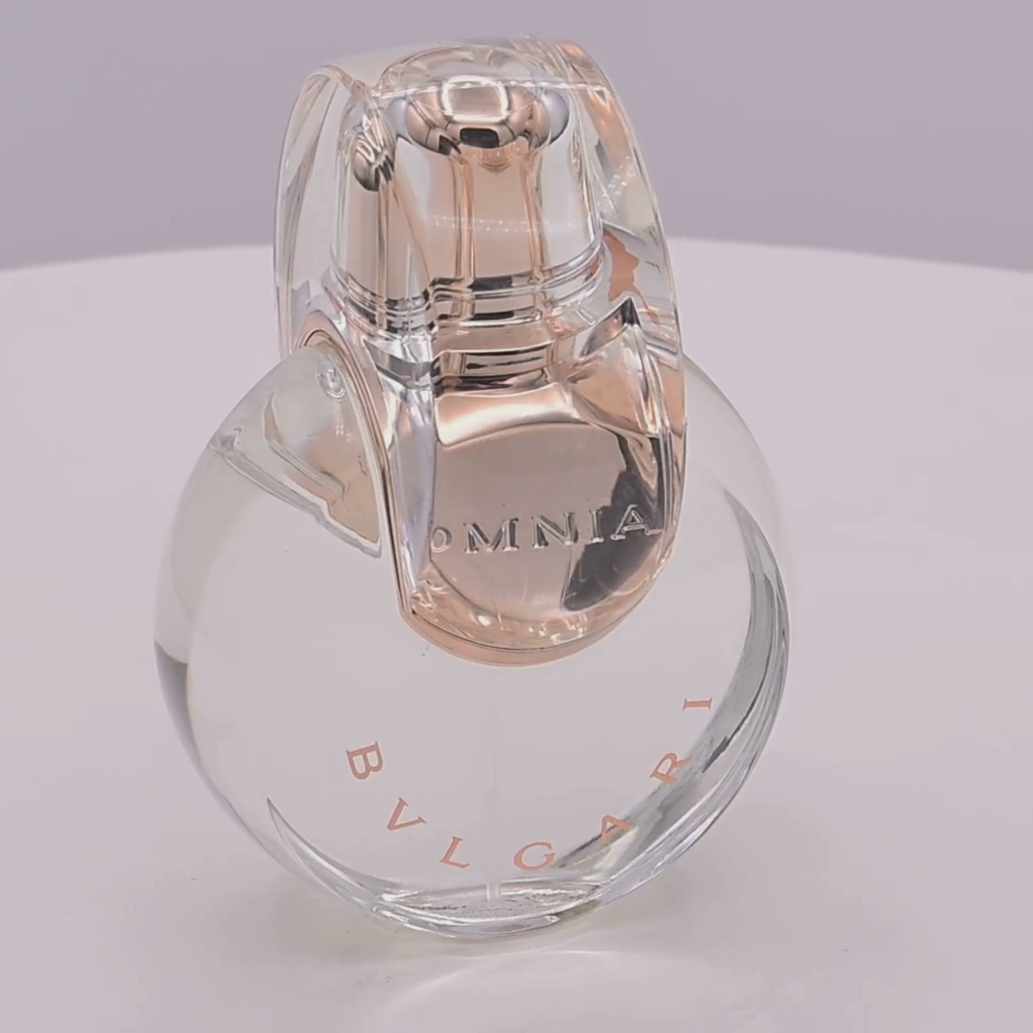 Bvlgari perfume bottle rotating on a white podium