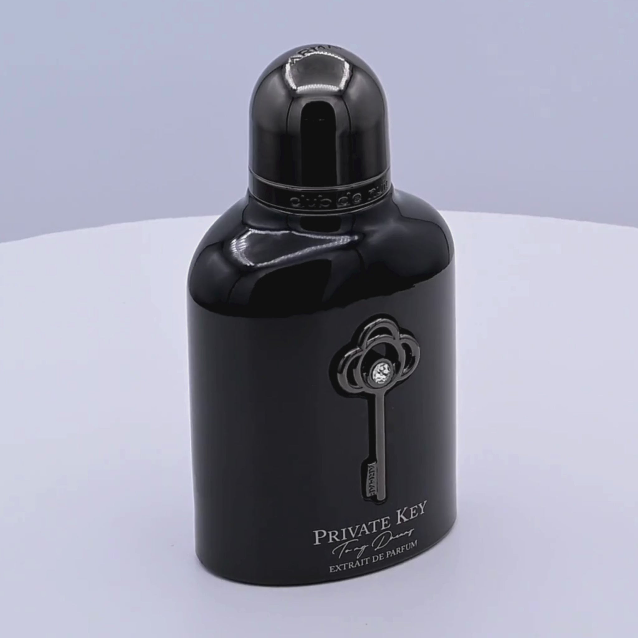 Black Armaf Private Key perfume bottle rotating on a white podium