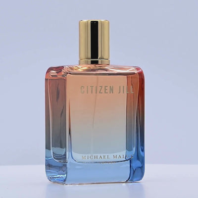 Perfume bottle with gradient design and gold cap rotating on a white podium