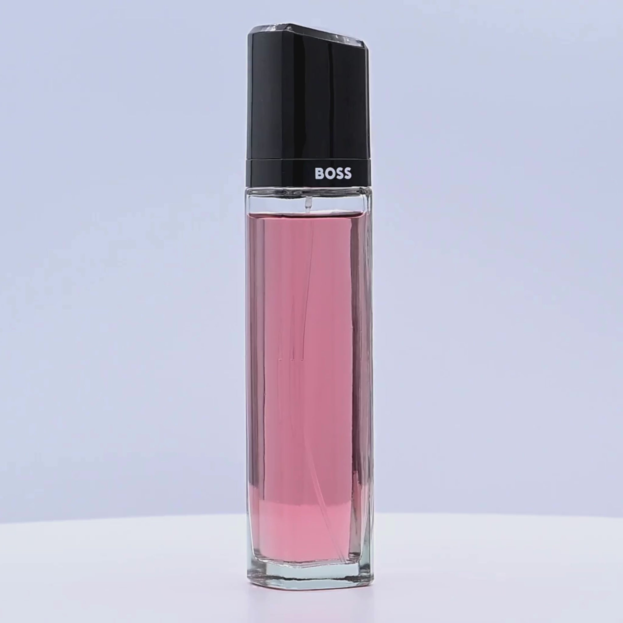 BOSS Ma Vie perfume bottle rotating on a white podium