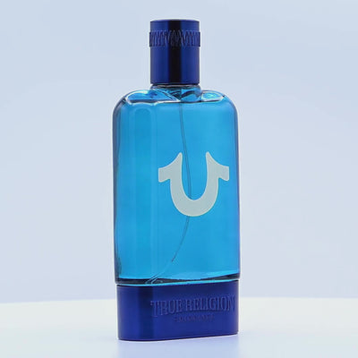 Blue perfume bottle with 'True Religion' branding rotating on a white podium