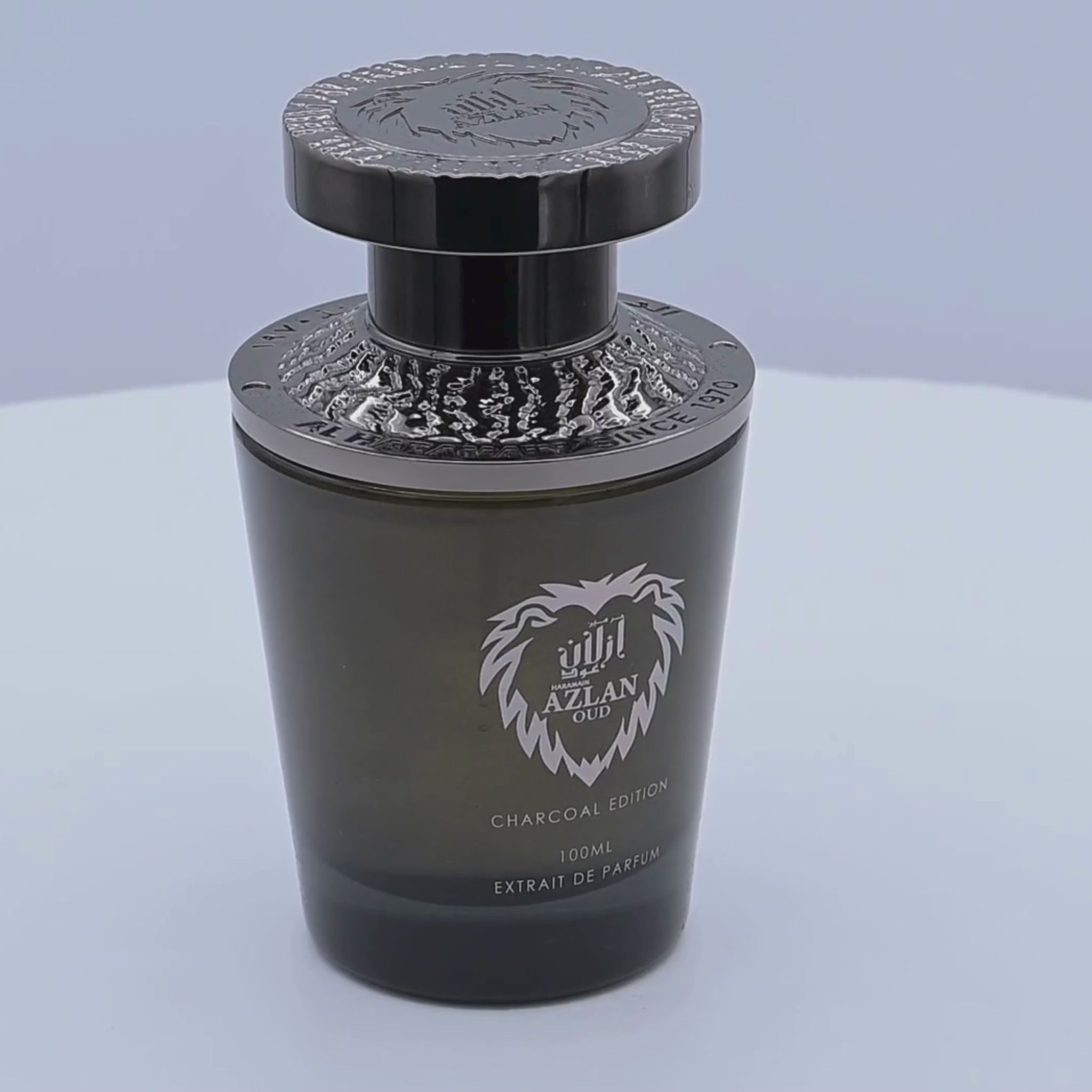 Al Haramain Azlan Oud perfume bottle rotating on a white podium