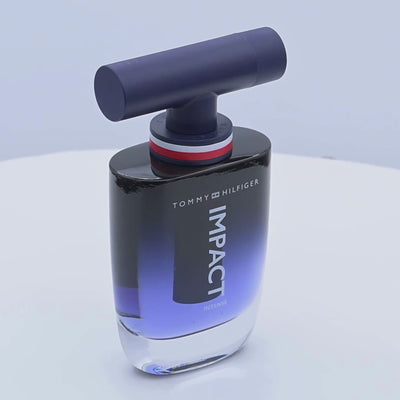 Tommy Hilfiger Impact Intense perfume bottle rotating on a white podium
