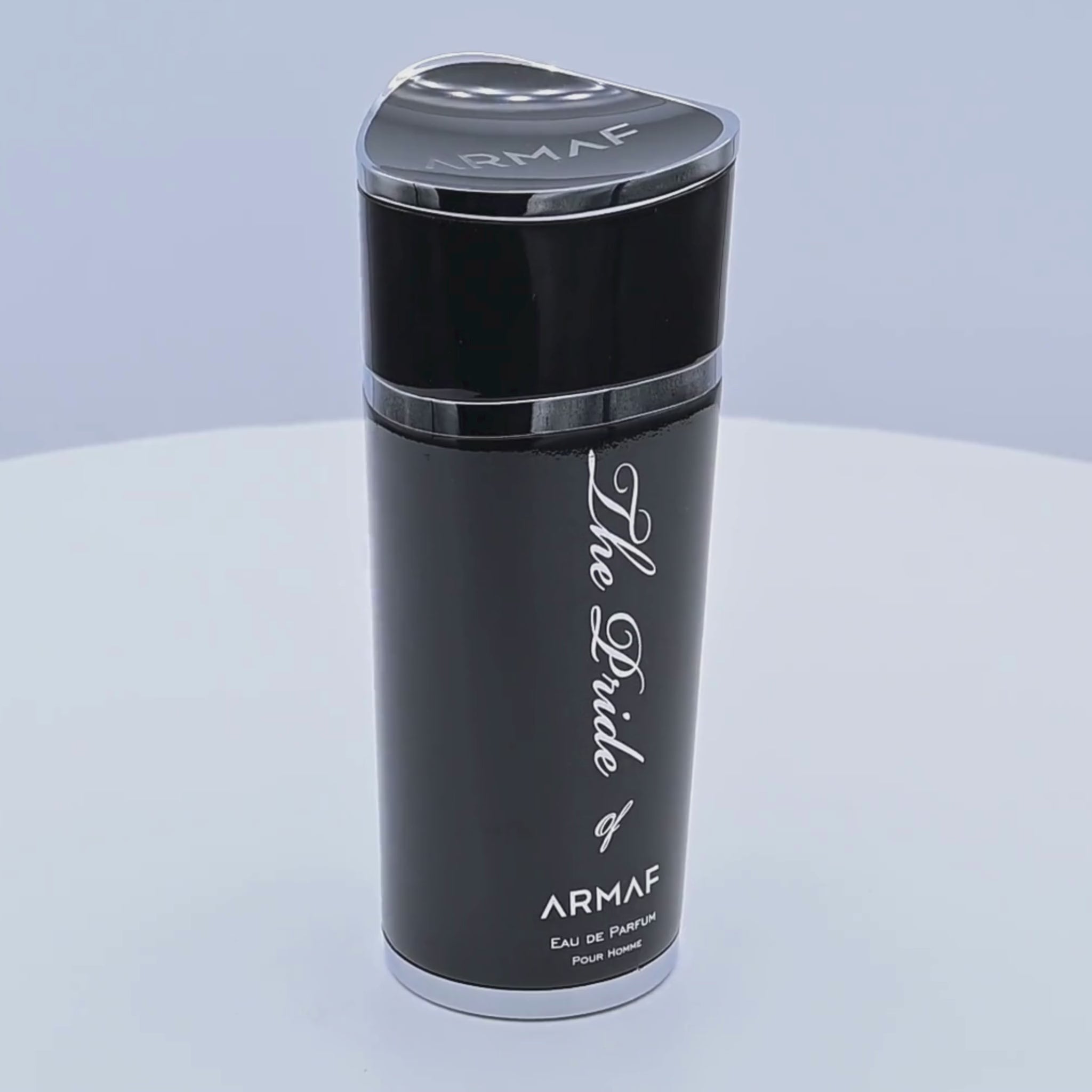 Black Armaf perfume bottle rotating on a white podium