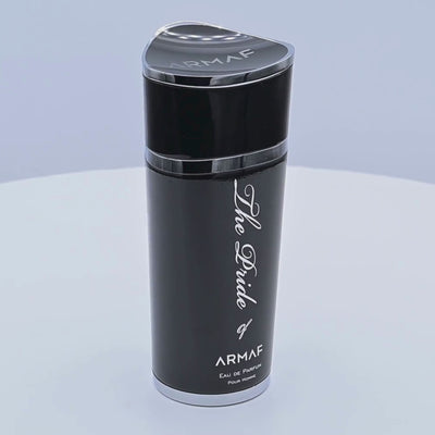 Black Armaf perfume bottle rotating on a white podium