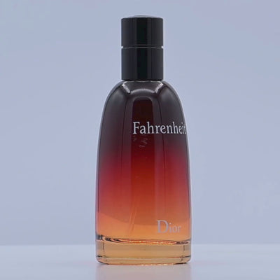 Dior Fahrenheit perfume bottle rotating on a white podium