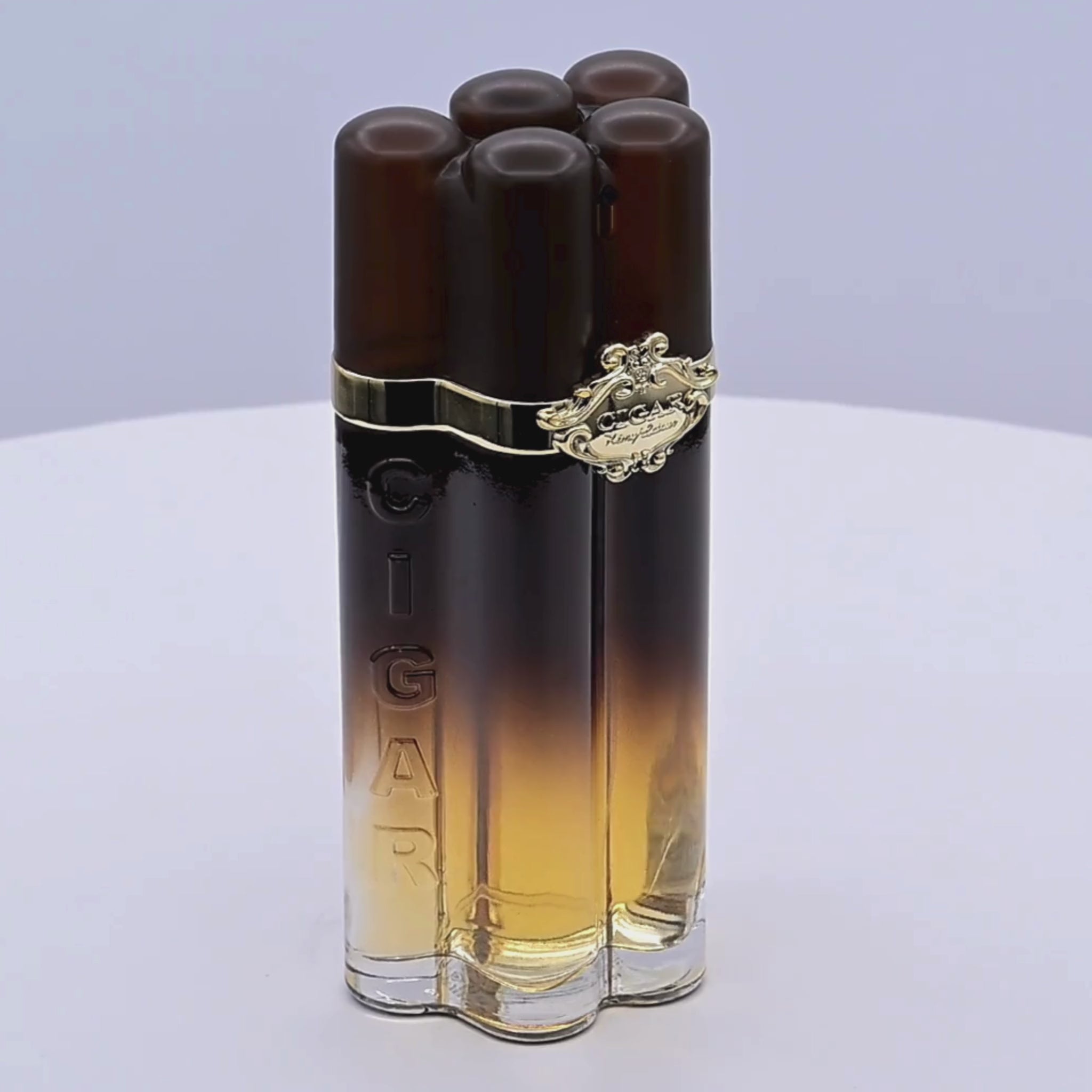 Cigar-shaped perfume bottles rotating on a white podium