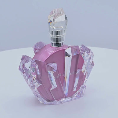 Pink perfume bottle rotating on a white background 