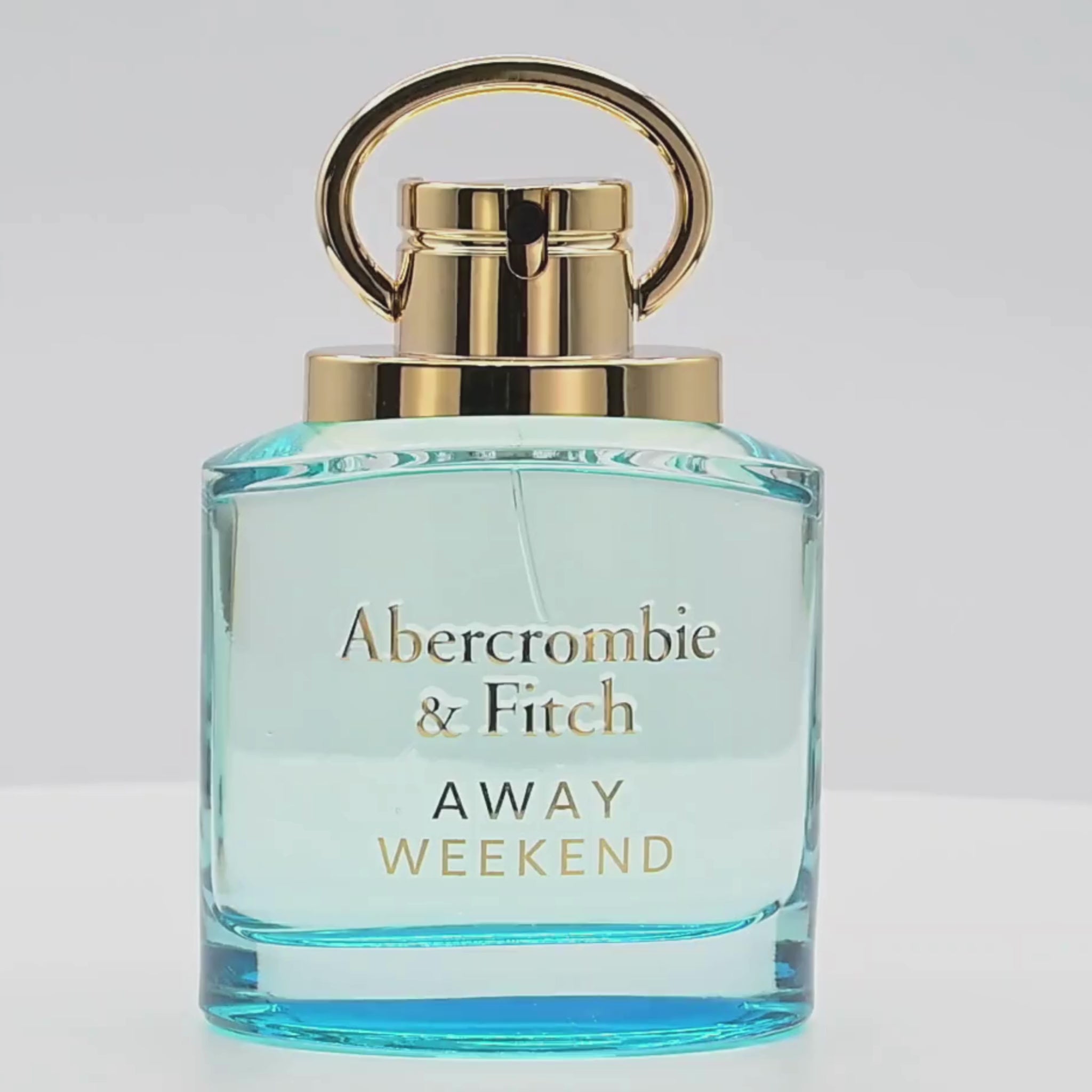 A bottle of Abercrombie & Fitch perfume rotating on a white podium
