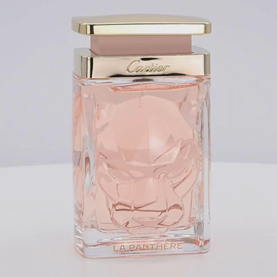 Cartier La Panthere perfume bottle rotating on a white podium
