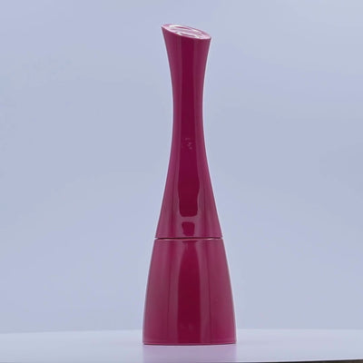 Red and pink perfume bottle rotating on a white podium