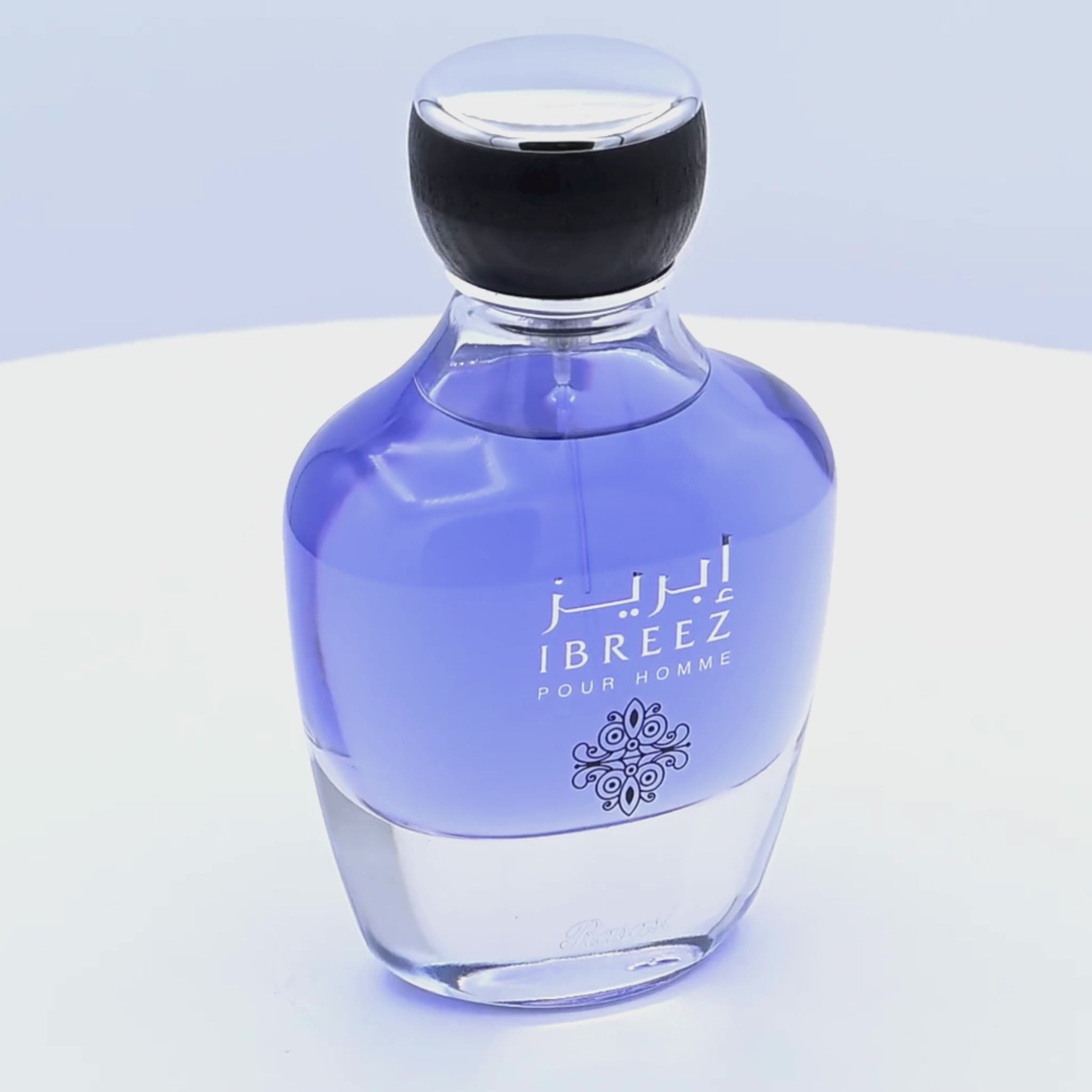 Perfume bottle labeled 'Ibreez Pour Homme' rotating on a white podium