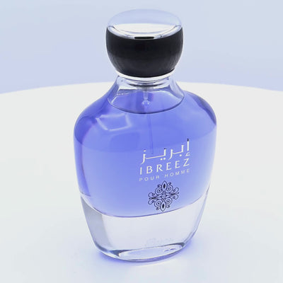 Perfume bottle labeled 'Ibreez Pour Homme' rotating on a white podium