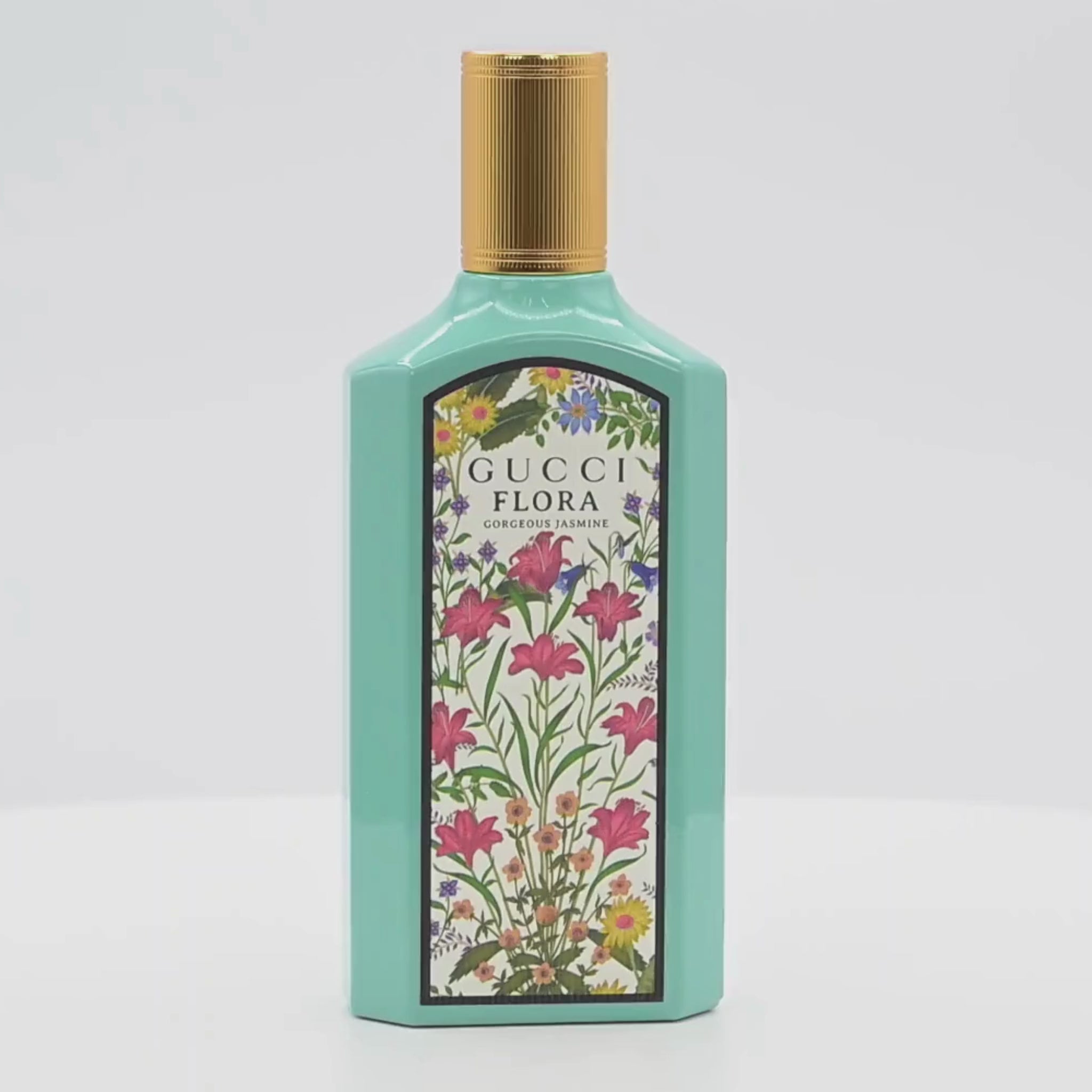 Gucci Flora perfume bottle rotating on a white podium
