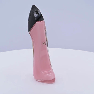 Carolina Herrera Good Girl Blush perfume bottle rotating on a white podium