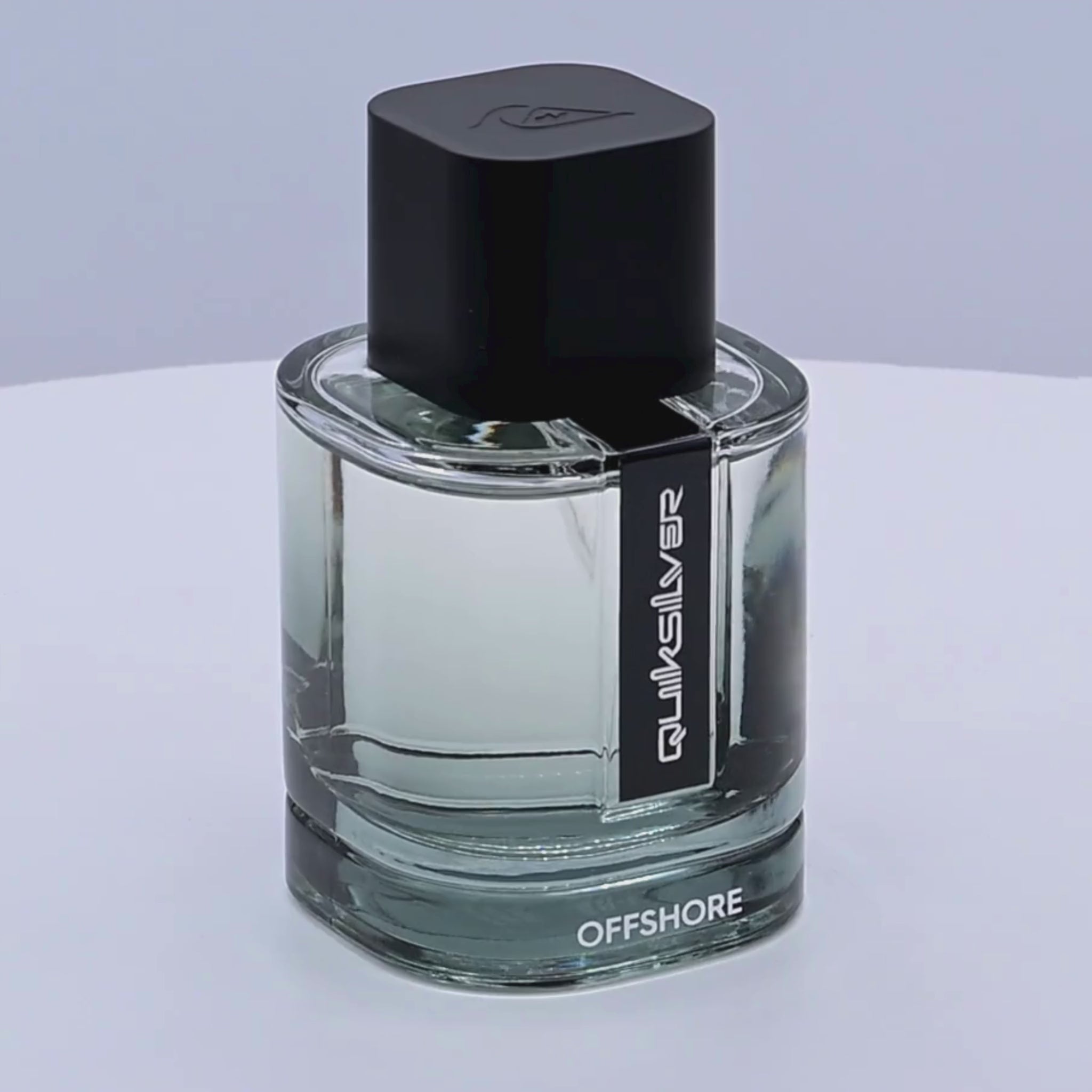 Quiksilver offshore perfume bottle rotating on a white podium