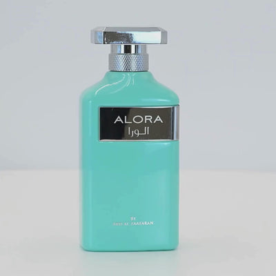 Alora perfume bottle rotating on a white podium