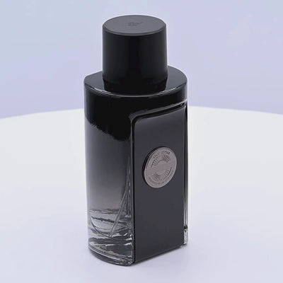 Black perfume bottle rotating on a white podium