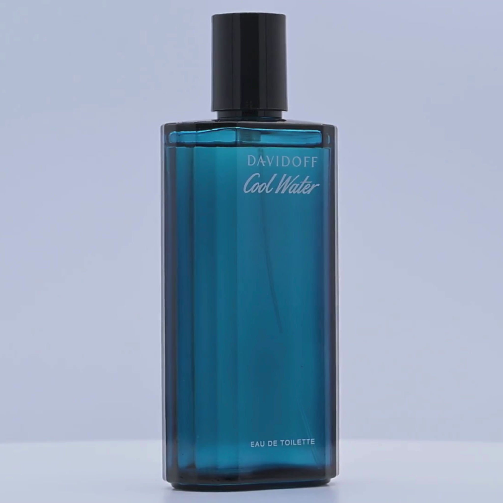 Blue Davidoff Cool Water eau de toilette bottle rotating on a white podium