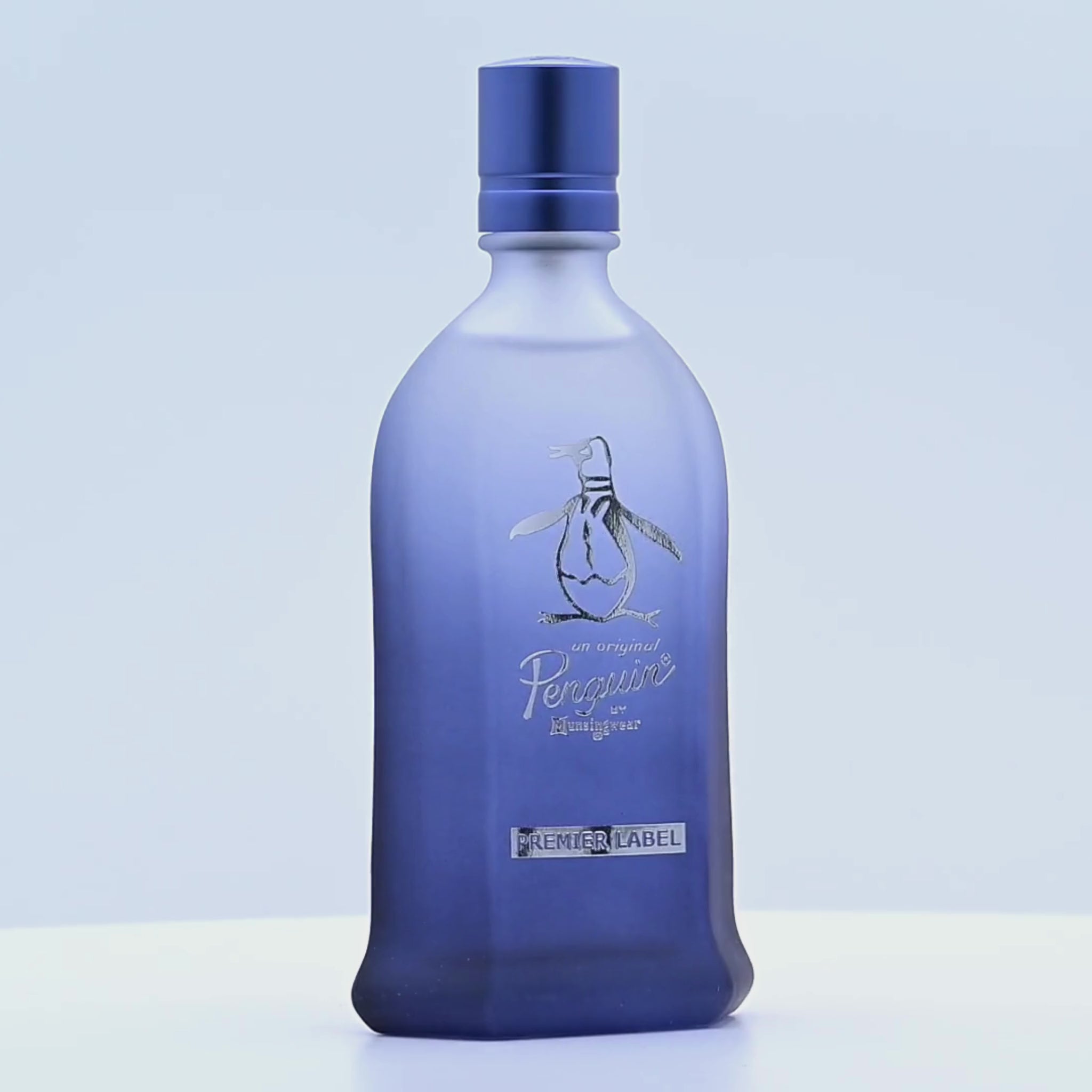 Penguin Montegoar perfume bottle rotating on a white podium