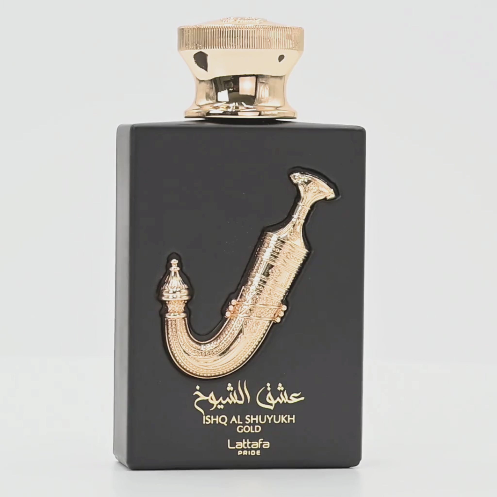 Ishq Al Shuyukh Gold perfume bottle rotating on a white podium
