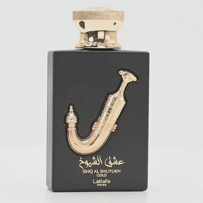 Ishq Al Shuyukh Gold perfume bottle rotating on a white podium
