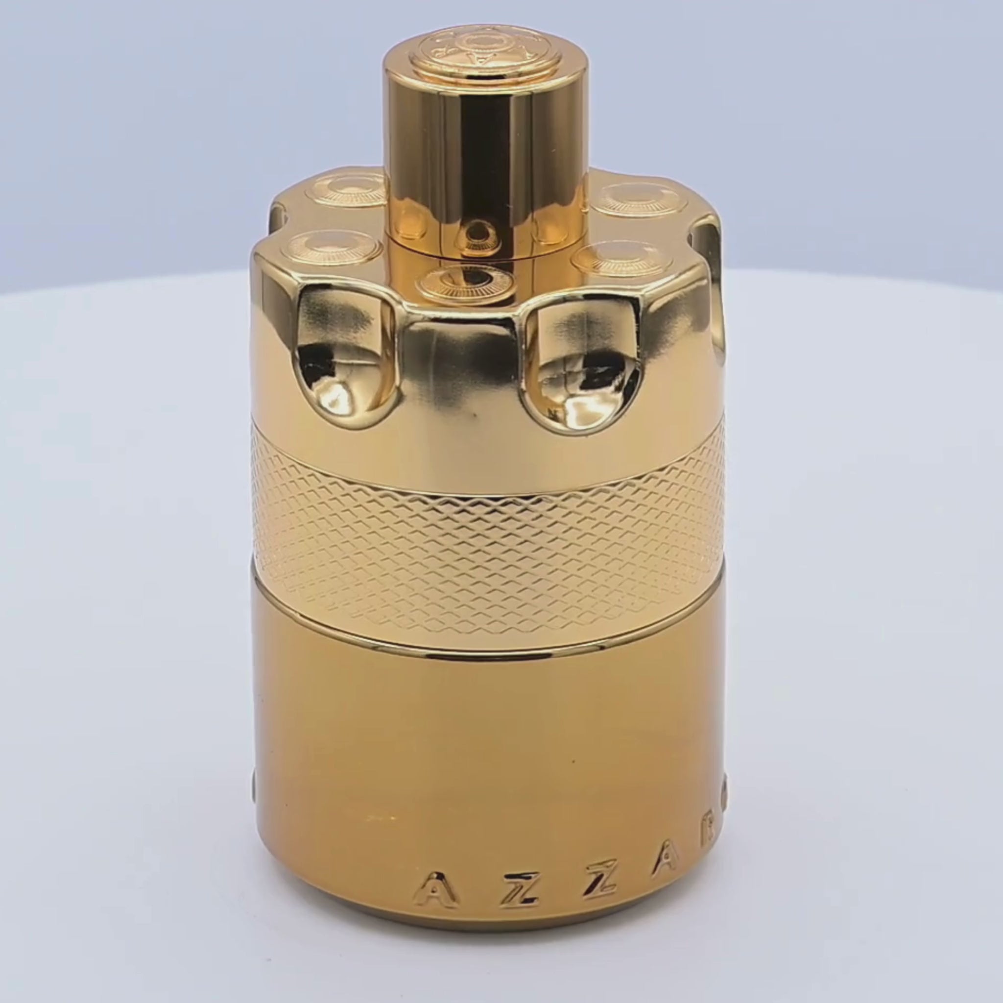 Gold Azzaro perfume bottle rotating on a white podium