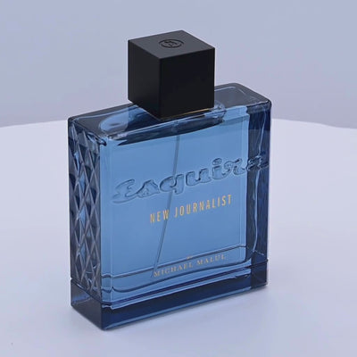 Esquire New Journalist perfume bottle rotating on a white podium