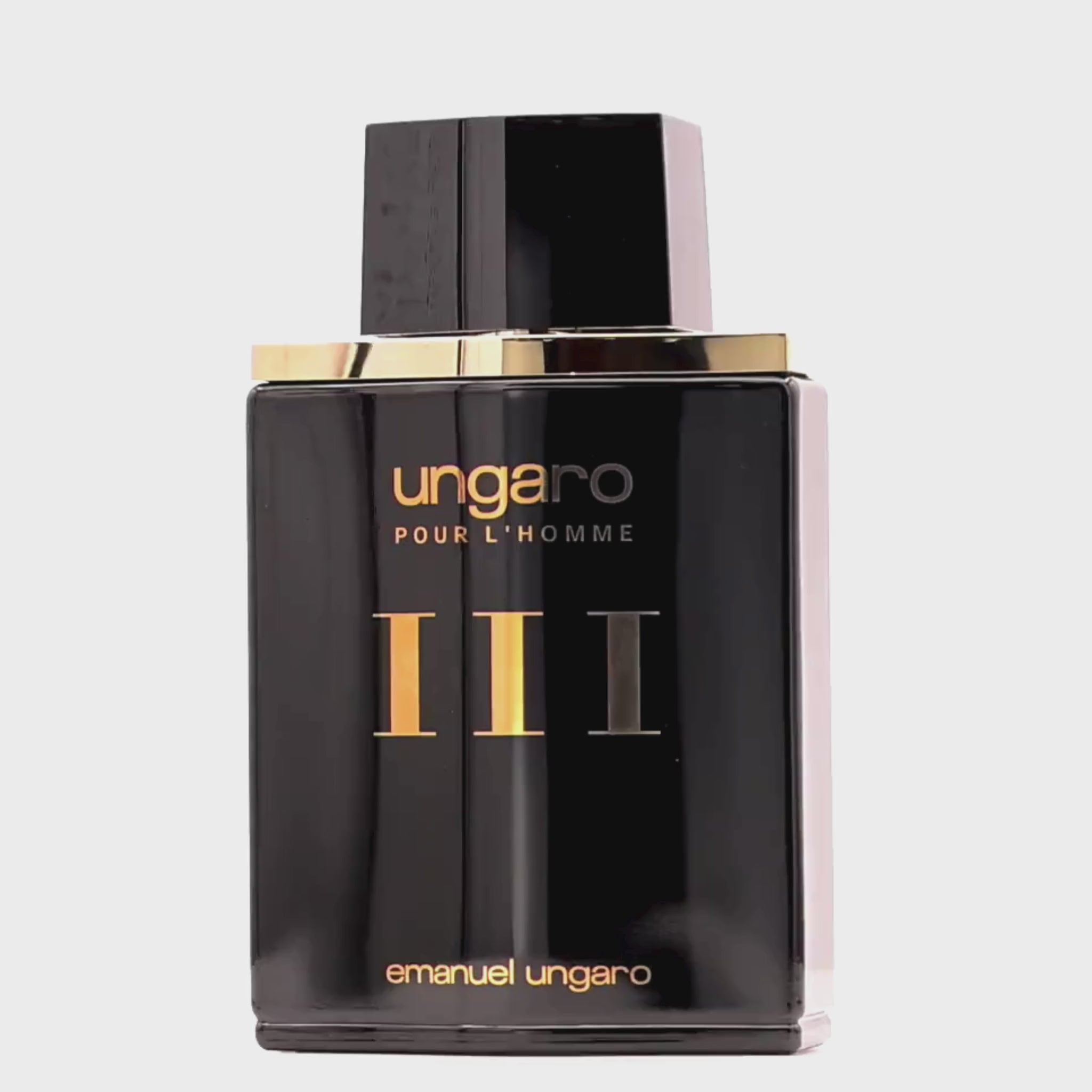 Perfume bottle labeled 'Ungaro Pour L'Homme' by Emanuel Ungaro rotating on a white podium