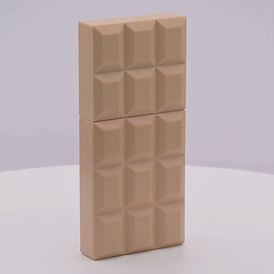 Rectangular chocolate bar shaped perfume bottle with a geometric pattern rotating on a white podium