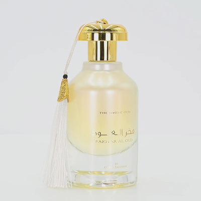 Fakhra Al Oud perfume bottle rotating on a white podium
