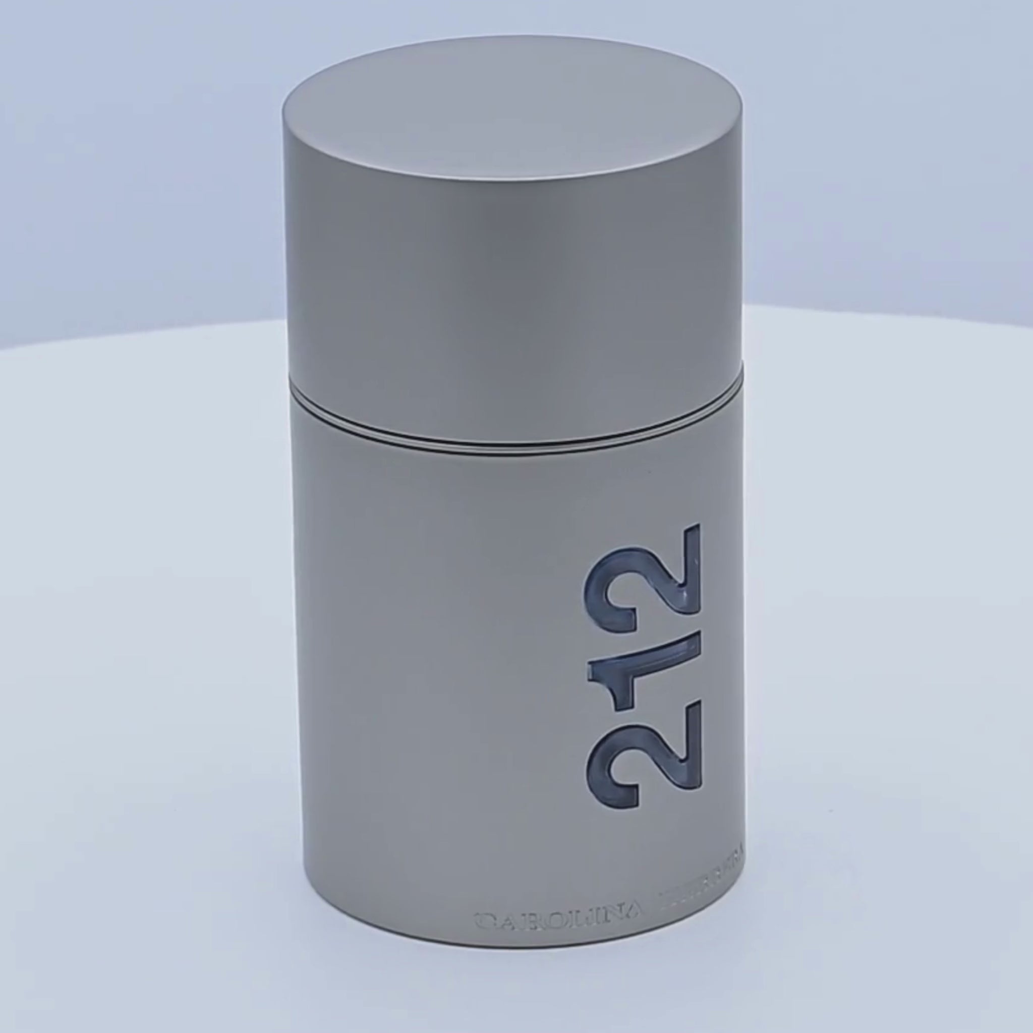 Carolina Herrera 212 Men NYC perfume bottle rotating on a white podium