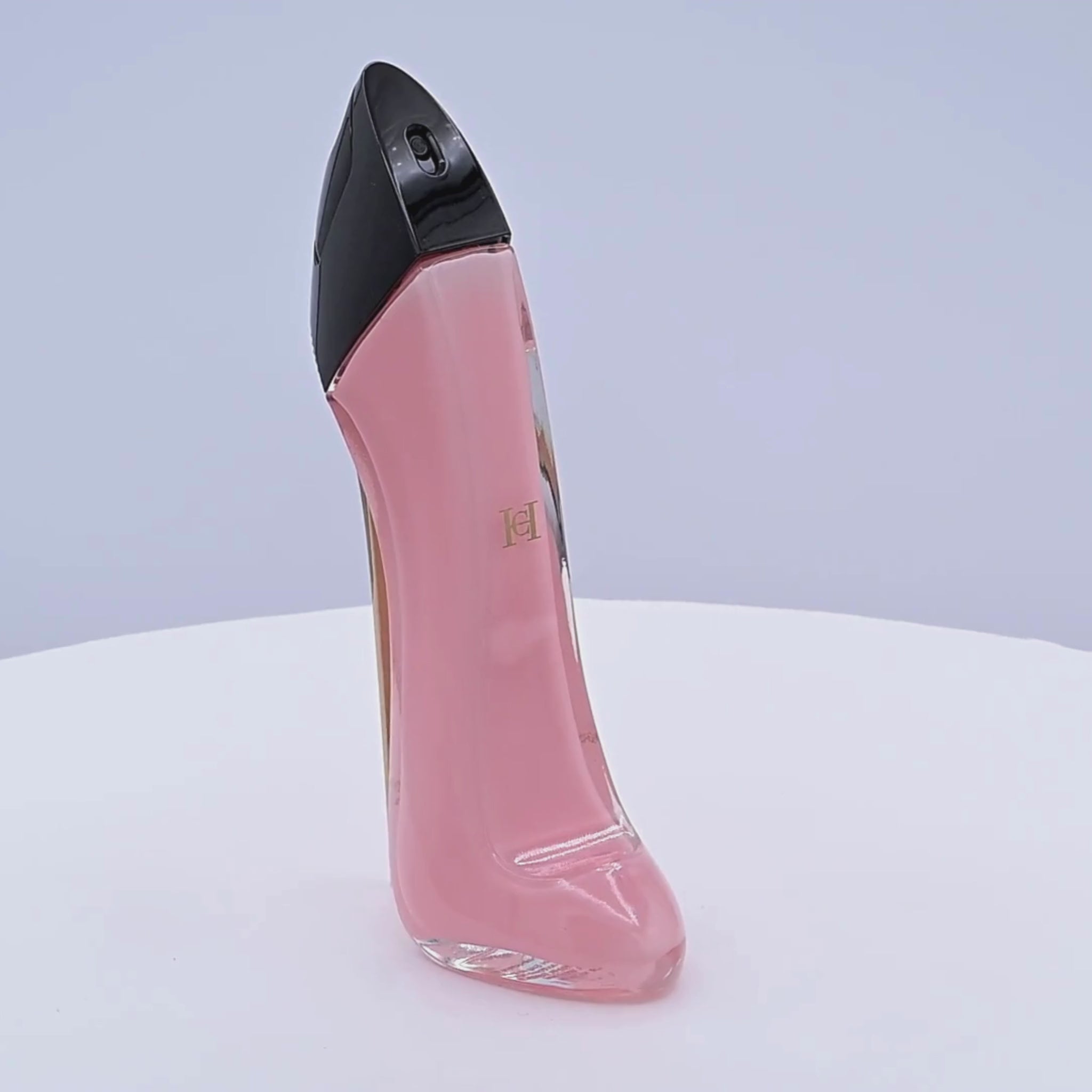 Perfume bottle of 'Good Girl' rotating on a white podium