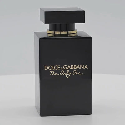 Dolce & Gabbana perfume bottle rotating on a white podium
