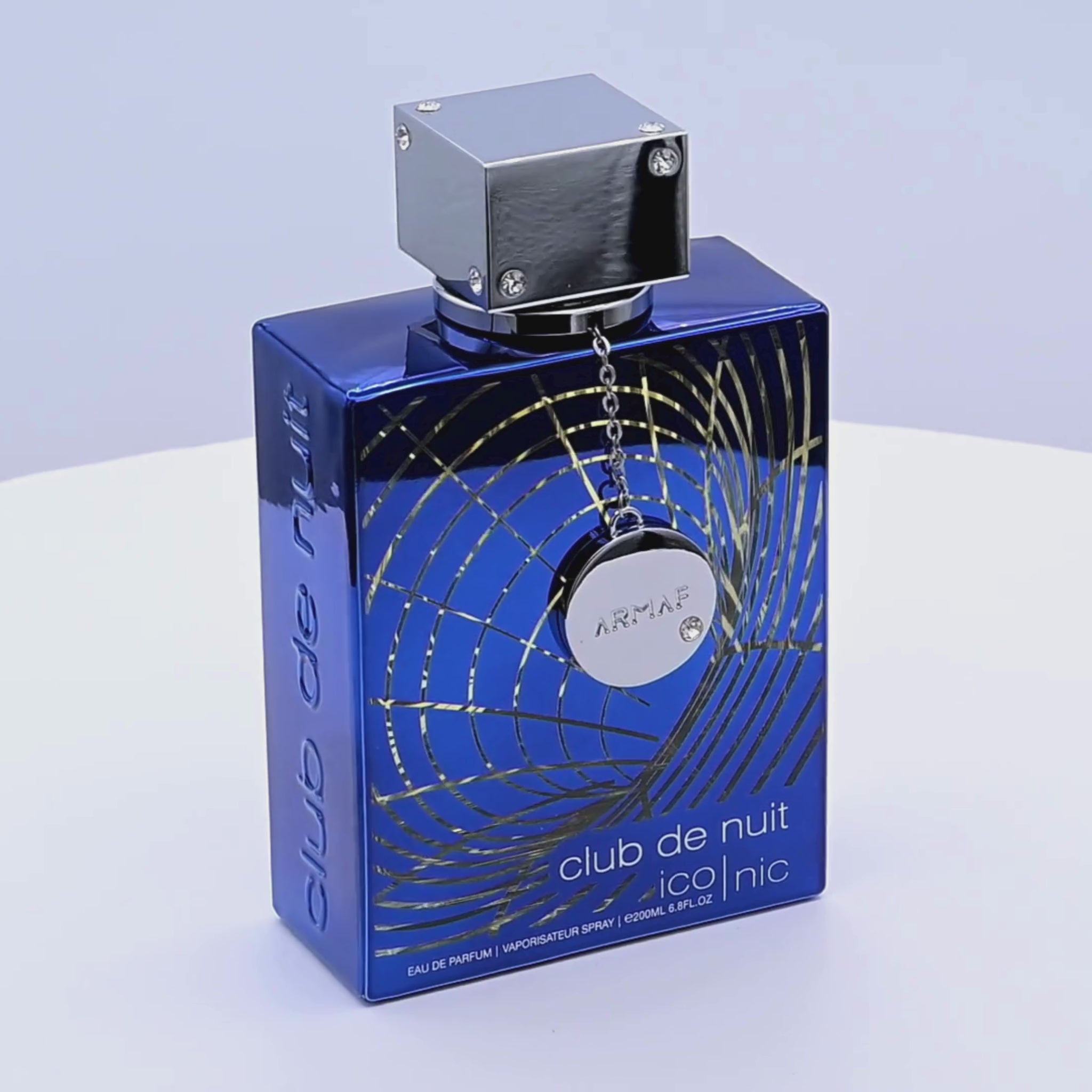 Blue Armaf Club de Nuit perfume bottle rotating on a white podium