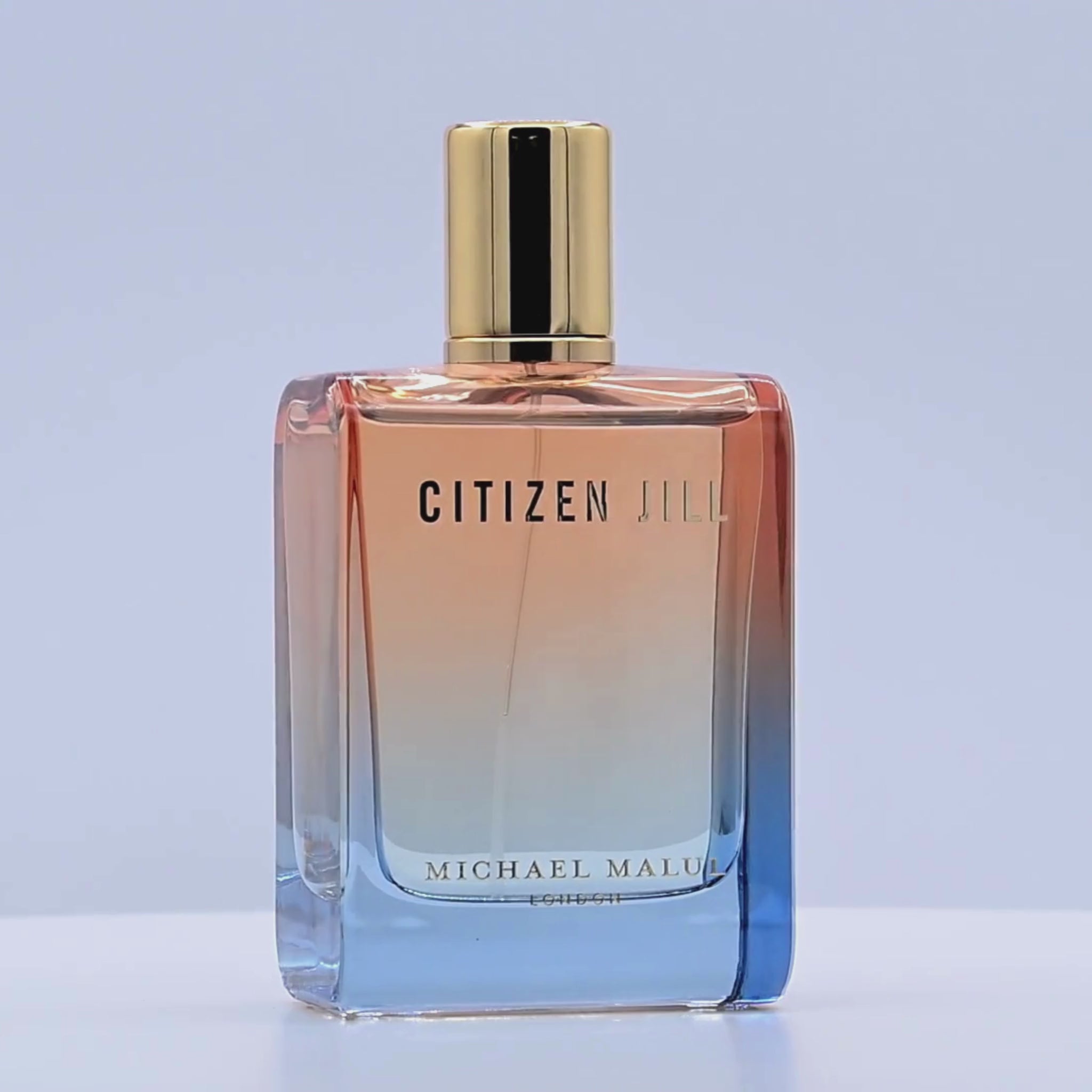 Perfume bottle  with 'Citizen Jill' branding rotating on a white podium