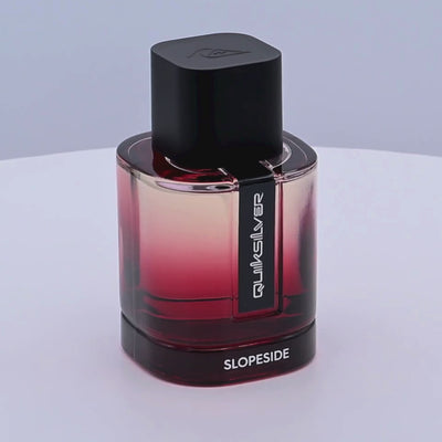 Quiksilver Slopeside perfume bottle with gradient design rotating on a white podium