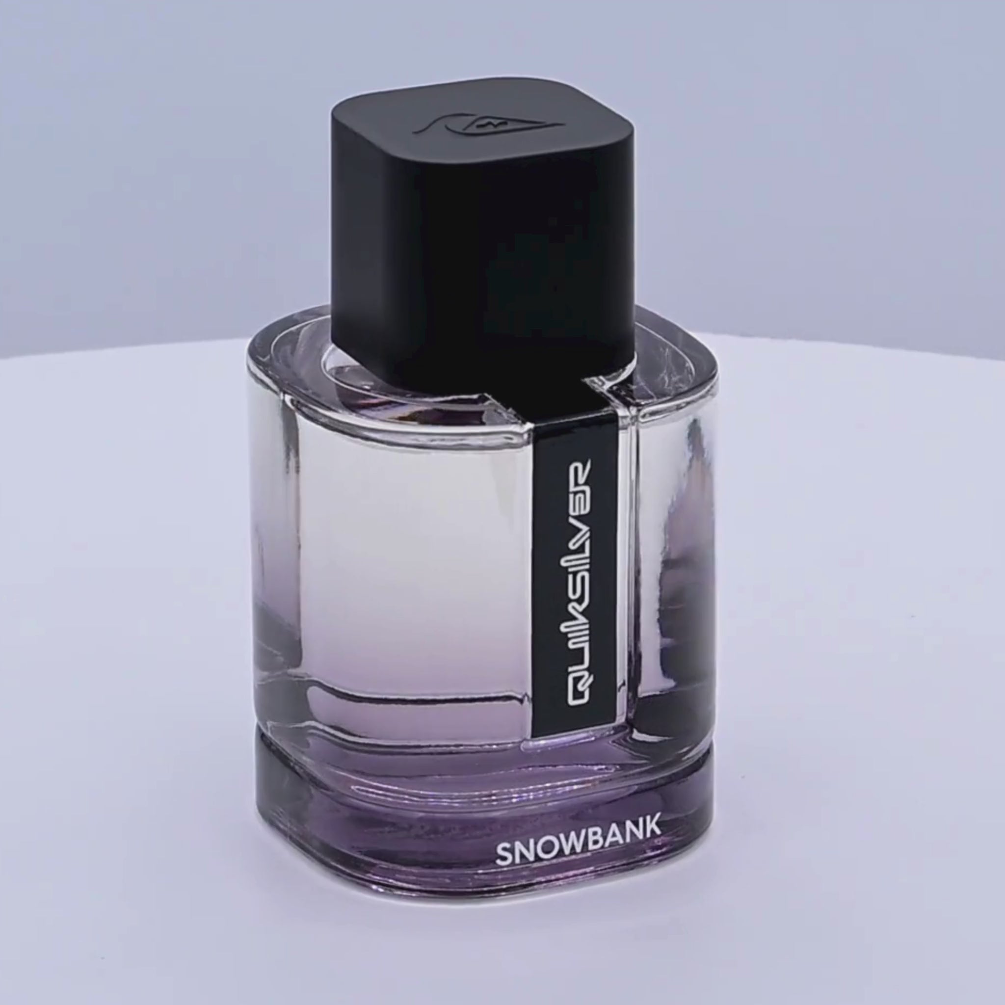 Quiksilver Snowbank perfume bottle rotating on a white podium